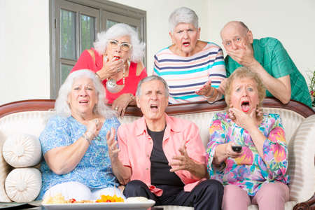 Six senior friends reacting to bad news televisionの写真素材