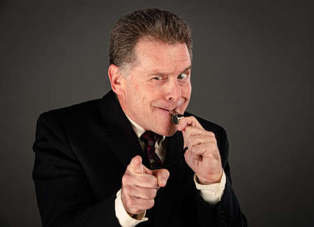 Angry male corporate or government whistleblower blowingの写真素材