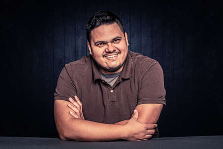 Cheerful Latino man smiling in a casual poseの写真素材