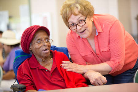 Hispanic and  African American women in a senior centerの写真素材
