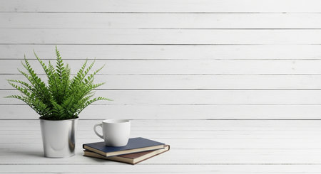 Coffee cup, books and plant on white wooden background.の素材