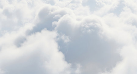 White fluffy clouds in the blue sky as a background for design.の素材