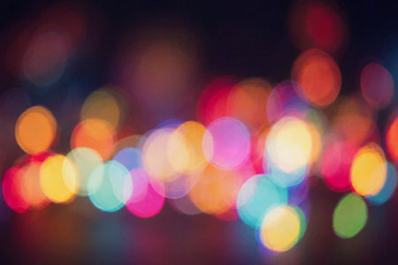 abstract background of colorful bokeh defocused lights on black backgroundの素材