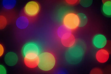 bokeh background of colorful christmas lights on black background.の素材