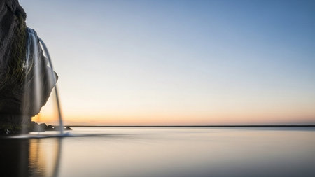Fountain on the shore of a lake at sunset. Long exposureの素材