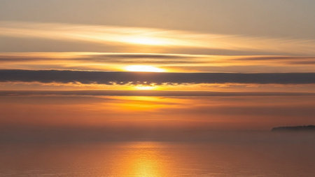 Sunset over the sea. Beautiful sunrise over the sea. The sun is reflected in the water.の素材