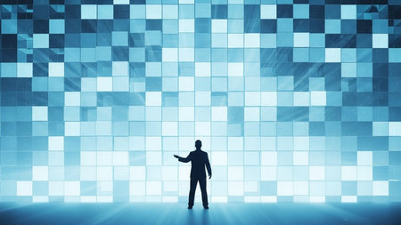 Silhouette of businessman standing in front of glowing blue cube wallの素材