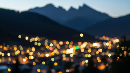 Bokeh of lights in the city with mountains in the backgroundの素材