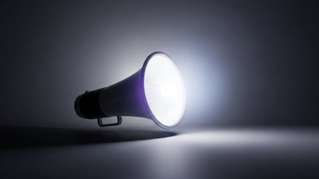 Megaphone on a dark background with a spotlight and copy spaceの素材