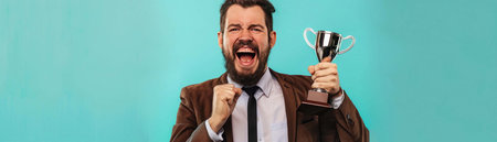A delighted man in a suit presenting a trophy with a sense of achievement and pride.の素材