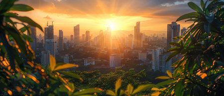City skyline at sunset, framed by lush green leavesの素材