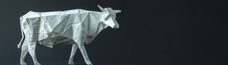 Black and white geometric origami cow, standing against a dark backgroundの素材