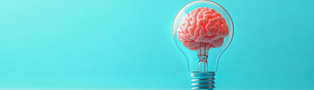 Lightbulb with a glowing brain inside, blue background, creative and innovative conceptの素材