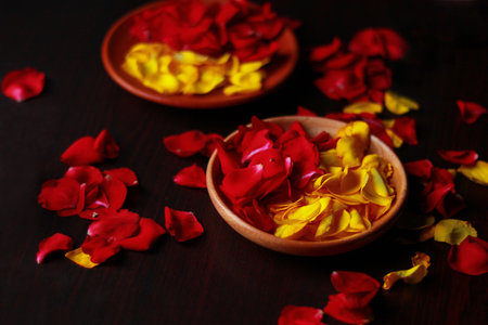Rose petals in a bowl on a wooden background. Rose petals.の写真素材