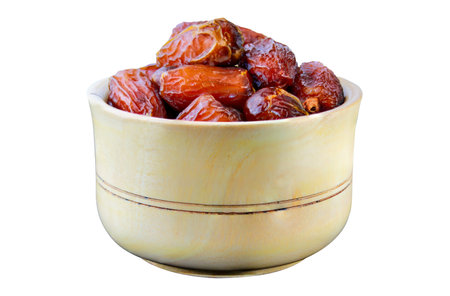 Dates fruit in a wooden bowl isolated on a white background, Clipping path includedの写真素材