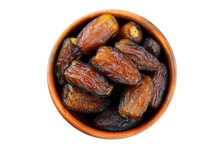 Dates fruit in a clay bowl isolated on a white background, Top view, Clipping path includedの写真素材
