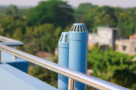 Vent Pipes on a Rooftop with a Scenic Background