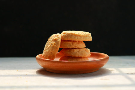 Cookies on a plate on a white table and a black background