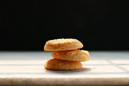 Cookies on a white table with a black background, shallow depth of fieldの写真素材