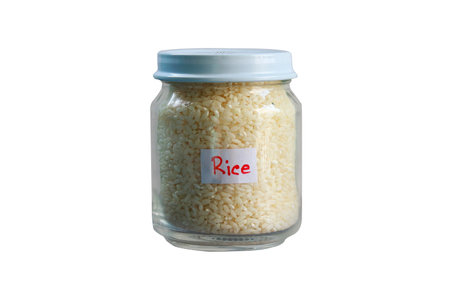Rice in glass jar isolated on white background with clipping path.の写真素材