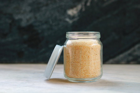 Rice in a glass jar on a white tableの写真素材