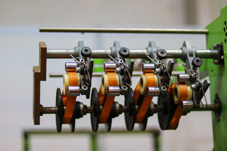 Production line of the spinning machine in a factory, close-up ofthe  photo