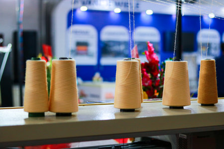 Spools of thread on the table in a sewing workshop. Selective focus.