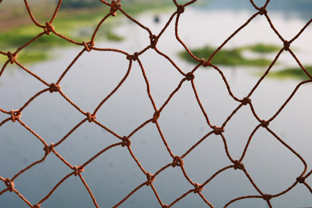 Close-up of a net with a water background. Selective focus.の写真素材