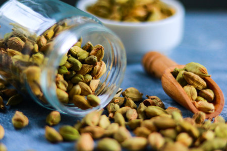 Cardamom in a glass jar on a blue background. Selective focus.の写真素材