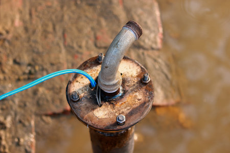 Professional installation of a deep tube well pump for groundwater extraction in a rural areaの写真素材