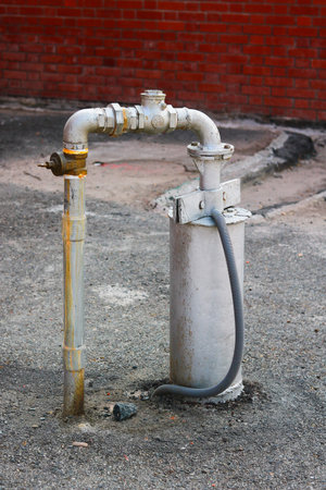 Industrial water pump system with metal pipes on asphalt groundの写真素材