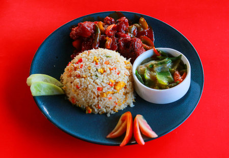 Delicious Indo-Chinese Fried Rice with Spicy Chili Chicken and Vegetable Curry Platterの写真素材