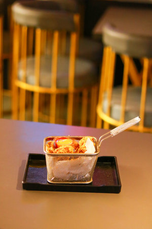 Crispy Fried Chicken Wings in Serving Basket with Dipping Sauceの写真素材