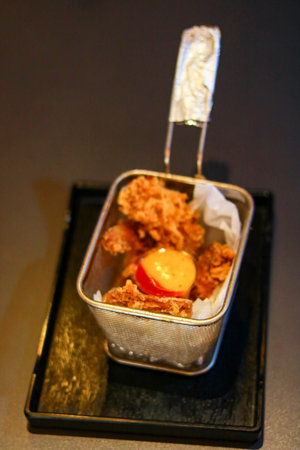 Crispy Fried Chicken Strips Served in a Mini Stainless Steel Deep Fryer Basketの写真素材