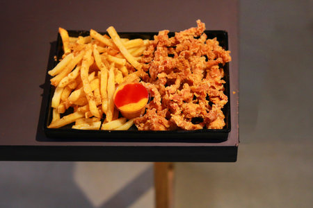 Platter of Classic French Fries and Popcorn Chicken with Dipping Sauceの写真素材