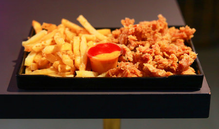 Platter of Classic French Fries and Crispy Popcorn Chicken with Dipping Sauceの写真素材