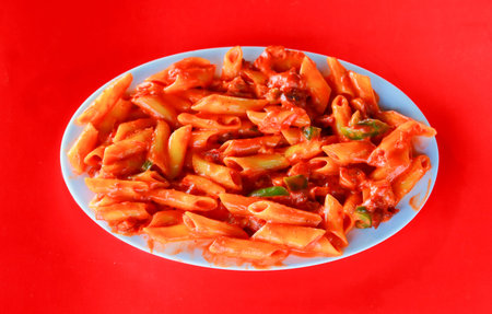 Delicious Penne Pasta in Spicy Tomato Sauce with Green Peppersの写真素材
