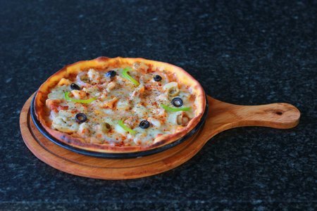 Freshly Baked Thin Crust Pizza with Olives, Peppers, and Melted Cheeseの写真素材