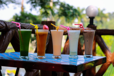 Collection of Various Colorful Fresh Fruit Juices and Milkshakes on a Tableの写真素材