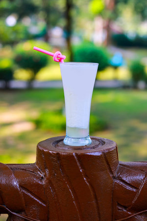 Traditional White Sweet Lassi or Yogurt Drink with Pink Straw in Sunlightの写真素材