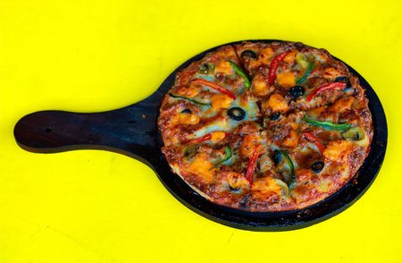 Homemade Pizza with Olives and Peppers Served on Wooden Pizza Paddleの写真素材