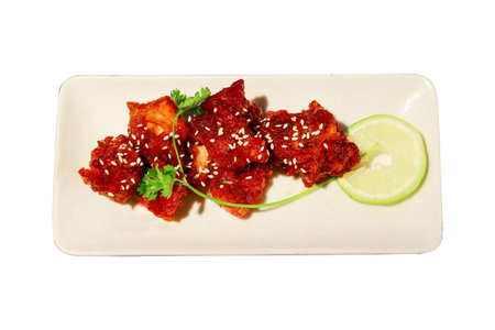 Sweet and Spicy Glazed Chicken Bites with Lemon and Sesame Seedsの写真素材