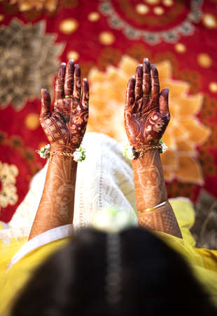 Beautiful Indian bride showing hands mehndi design. Pair of hands top view of the traditional henna design on bridals hand.の写真素材