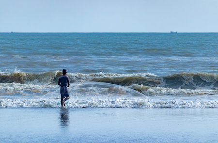 Photo Man fishing standing in water near shore sky drop plane sunny clear morning on a tropical beachの写真素材