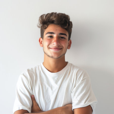 Portrait of a handsome young man with his arms crossed on white backgroundの素材