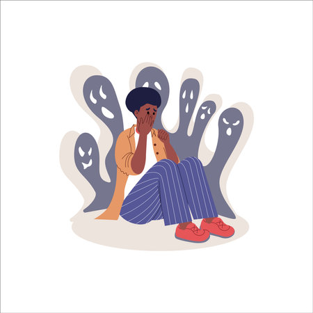 Sad young man in pajamas sitting on the floor and crying. Vector illustrationのイラスト素材