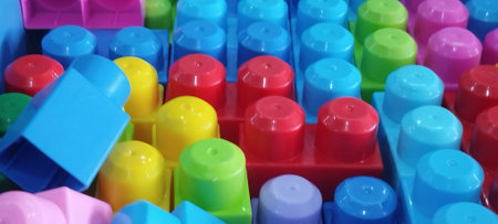 Colorful plastic building blocks on the floor. Close-up.の写真素材