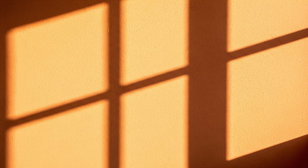 abstract shadow of window on orange wall for background and texture.