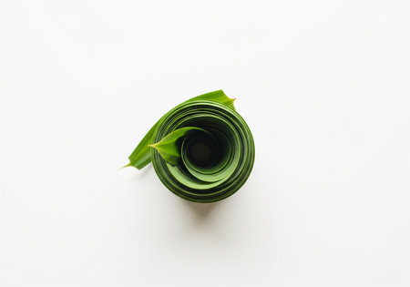 top view of green paper rolled up on white background with copy space