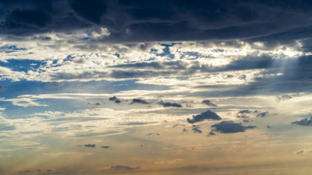 Sunset sky with clouds and sunbeams. Nature background.